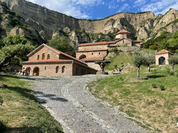 Shiomghvime monastery nestled against dramatic limestone cliffs