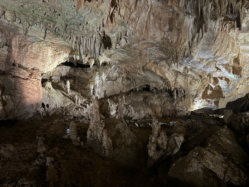 Large hall of Prometheus Cave with stalactites and stalagmites