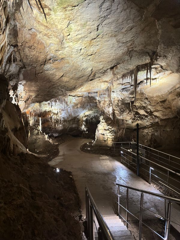 Illuminated tourist pathway along the cave walls